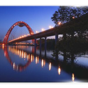 תמונת זכוכית של גשר אדום מואר עם השתקפות במי הנהר