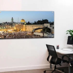 תמונת זכוכית פנורמית של הכותל המערבי בירושלים, עם כיפת הסלע המוזהבת, קהל מתפללים, והשמיים בגוון כחול עדין של בין ערביים.